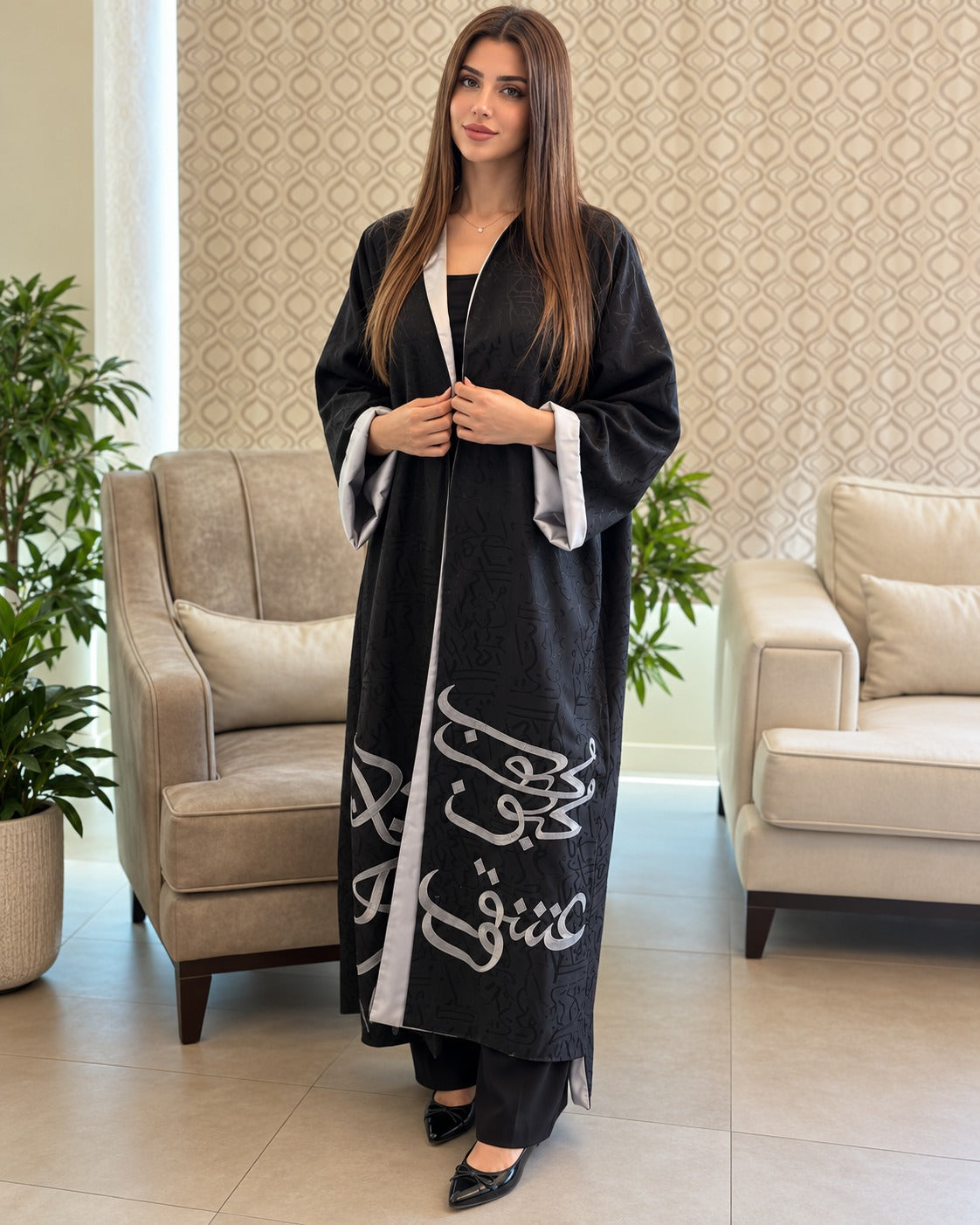 Harf black open-front abaya with silver-grey calligraphy, tonal patterning and long sleeves with contrasting turn-back cuffs, front view