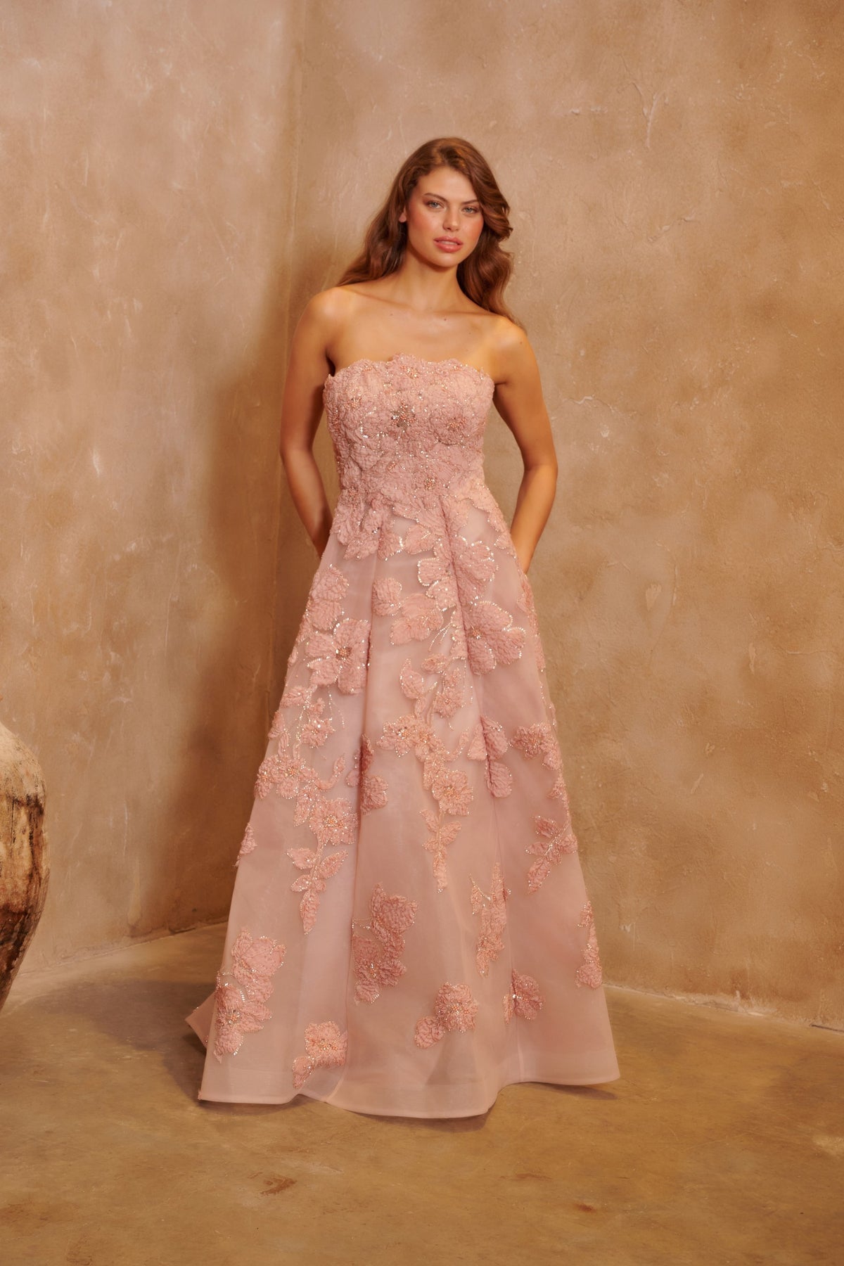 Petal Sonata blush gown with a strapless bodice, three-dimensional floral embellishment and a full skirt.