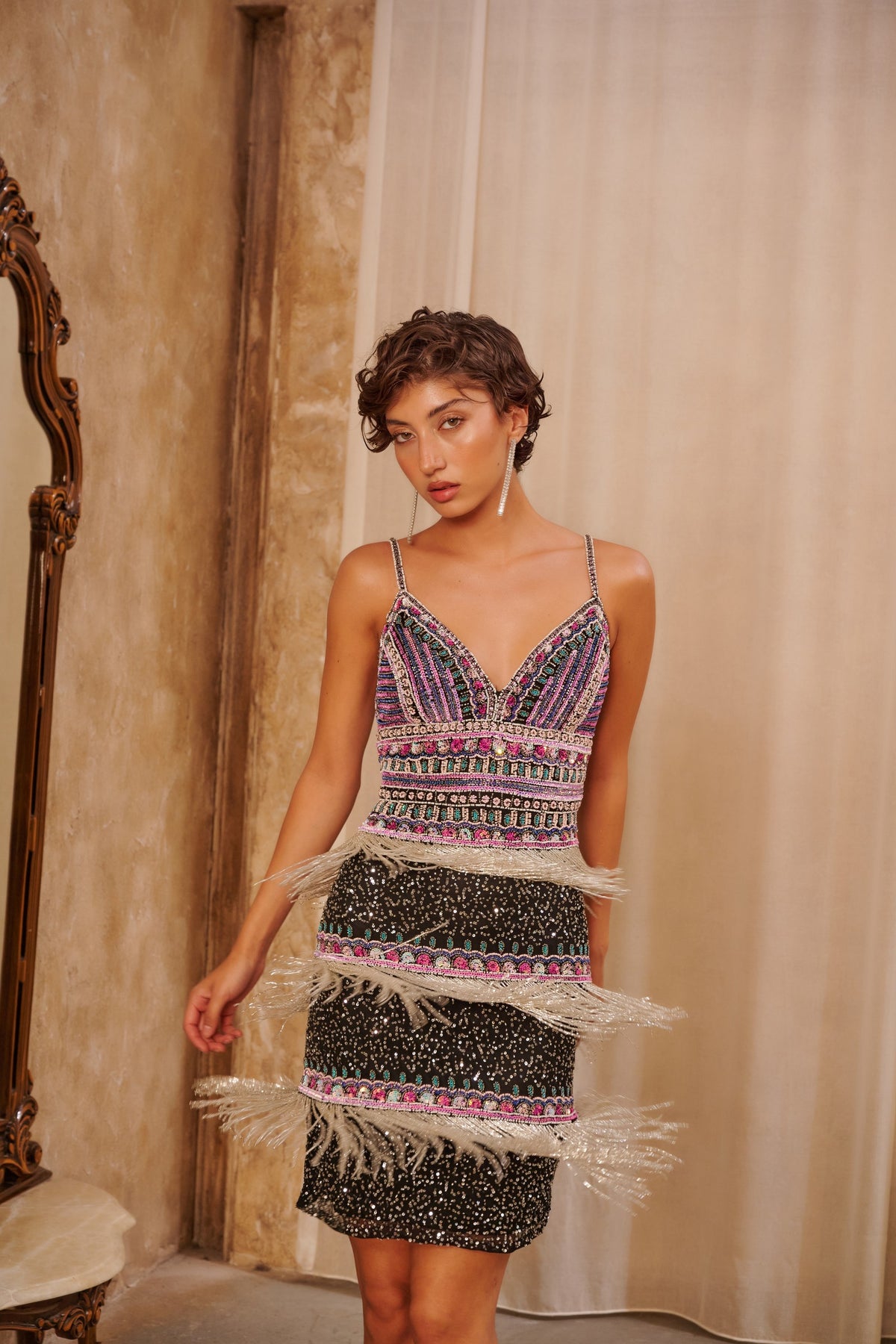 Rose Fringe embellished mini dress with multicolored beadwork, a deep V-neckline and layered blush fringe.
