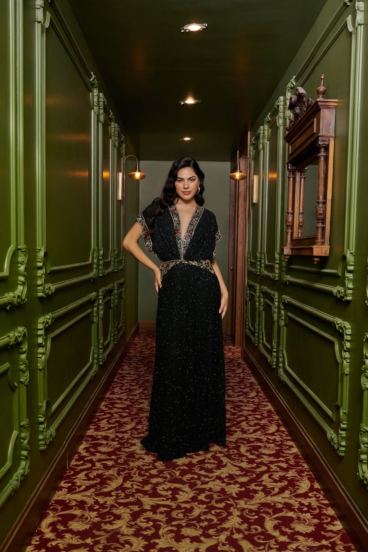 Black Jewel black tie dress with a deep V-neckline, multicolored embellishments, cap sleeves and a thigh-high slit.