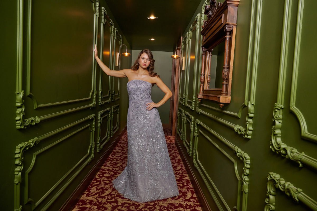 Silver Mist strapless silver grey evening gown with intricate beadwork, a fitted bodice and a floor-length A-line skirt.