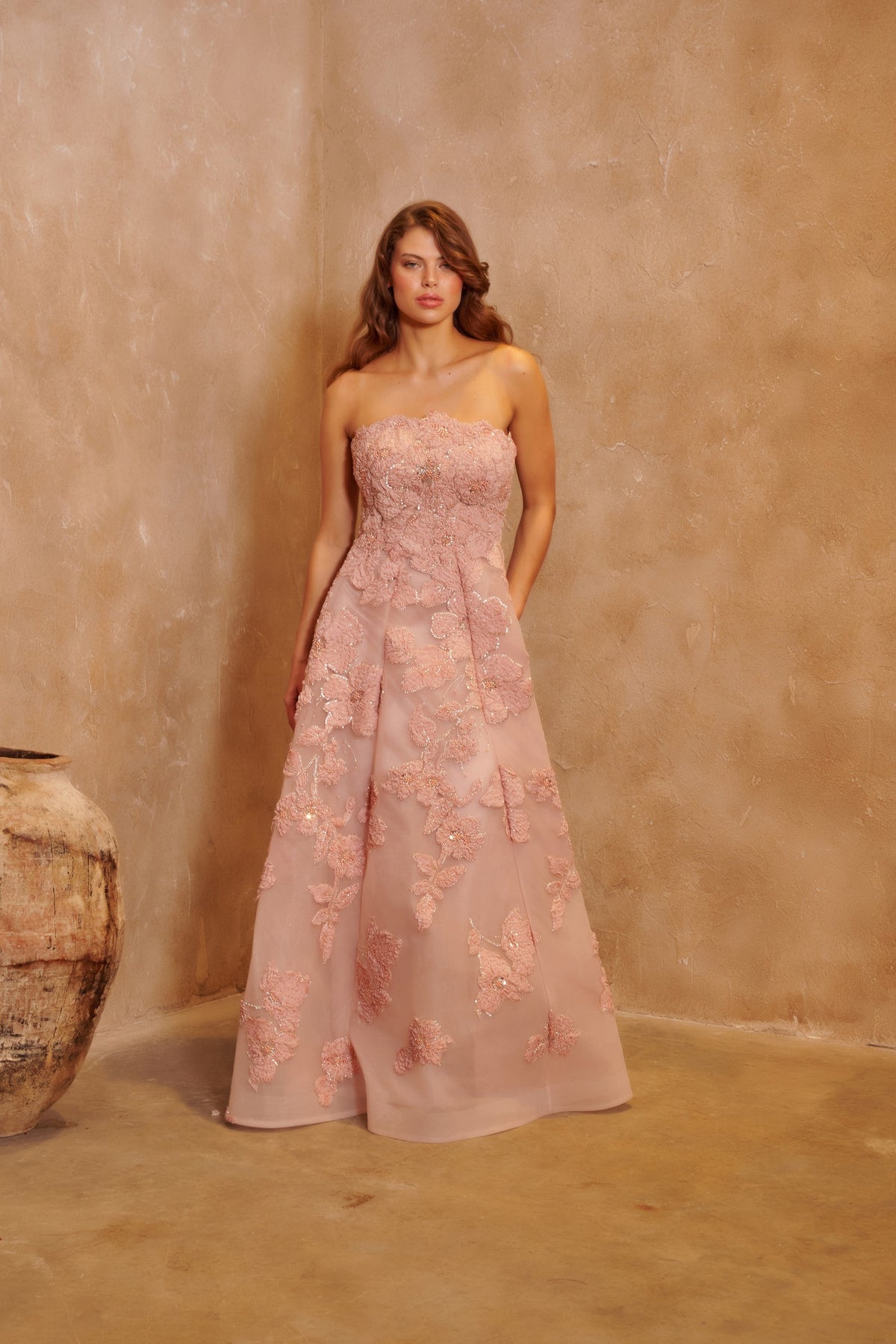 Petal Sonata blush gown with a strapless bodice, three-dimensional floral embellishment and a full skirt.
