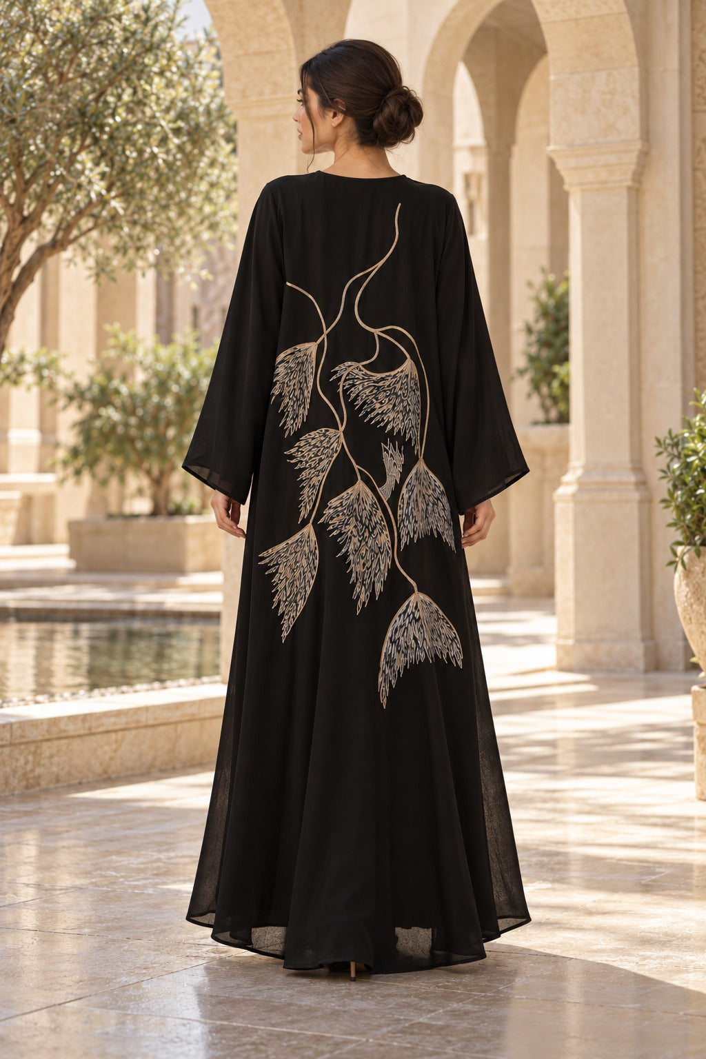 Willow black abaya with oversized botanical back detailing, champagne-toned accents and long, wide sleeves, back view