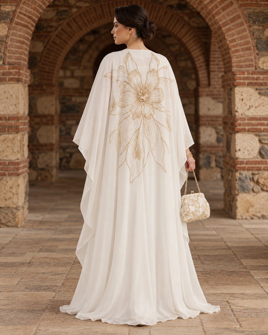 Zahra ivory kaftan abaya with an oversized gold floral motif, a rounded neckline and wide, draped sleeves, back view