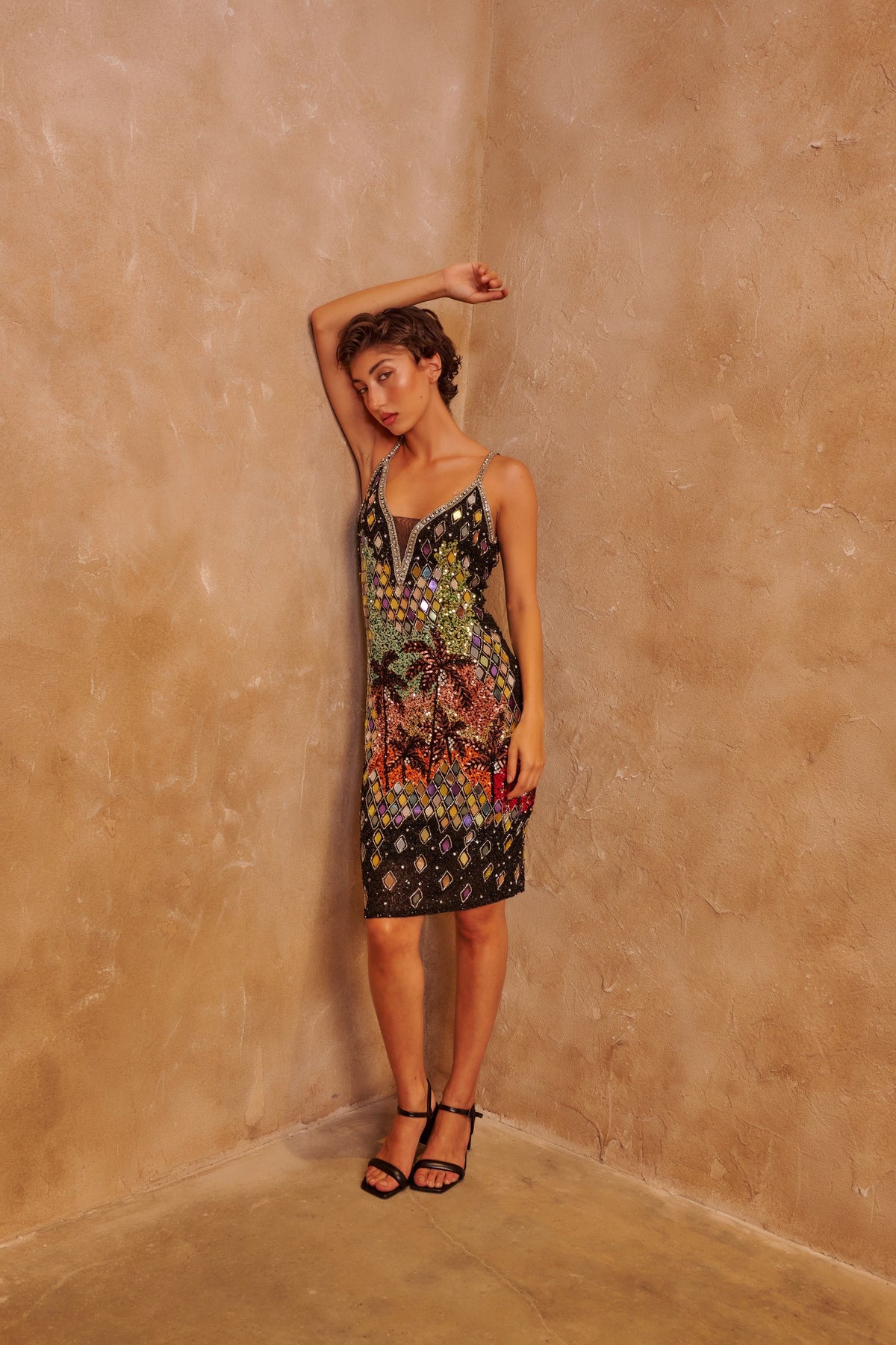 Mosaic Fire black fitted dress with multicolored mosaic sequins, a sleeveless neckline and a sleek silhouette.