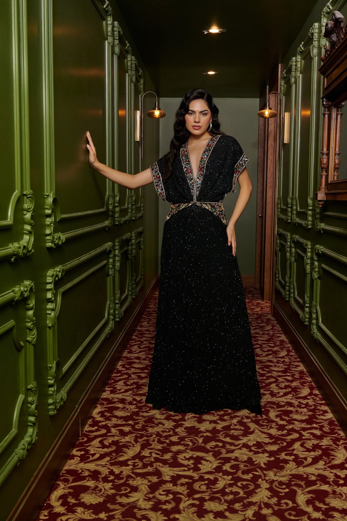 Black Jewel black tie dress with a deep V-neckline, multicolored embellishments, cap sleeves and a thigh-high slit.