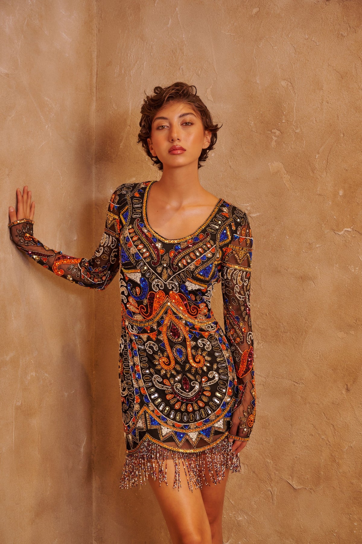 Sahara Jewel sand-toned dress with ornate multicolored embellishment and a sculpted fitted silhouette.