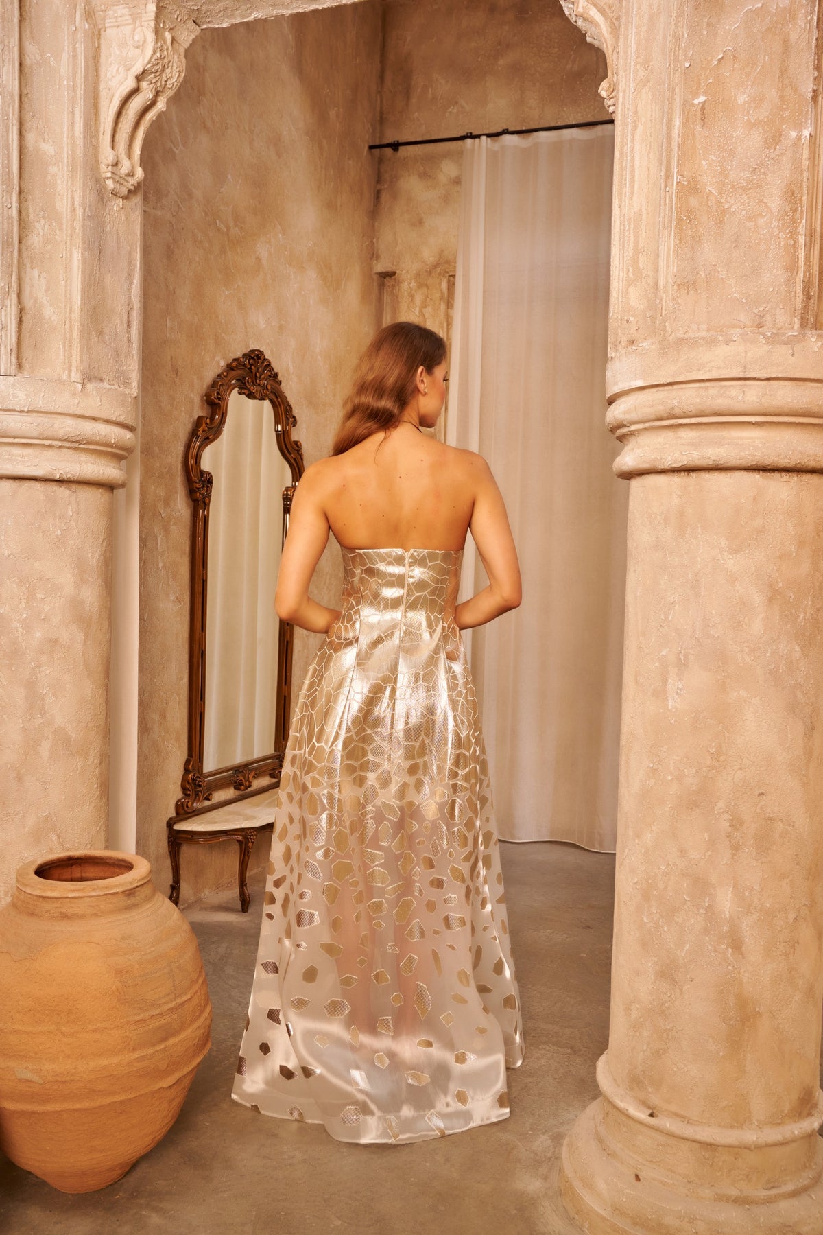 Golden Mirror strapless evening gown with reflective geometric detailing and a voluminous floor-length skirt.