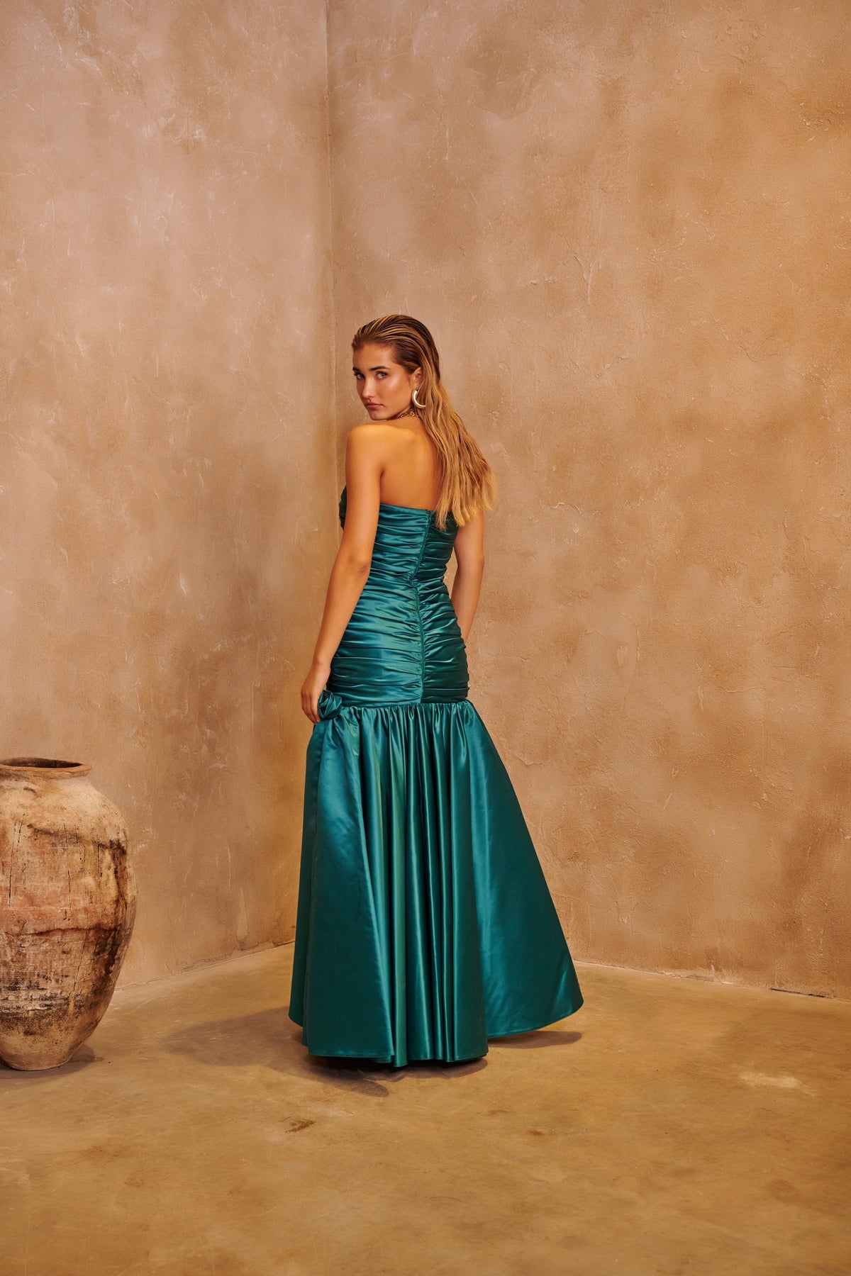 Emerald Rose green evening dress with floral-inspired embellishment and a sculpted fitted silhouette.