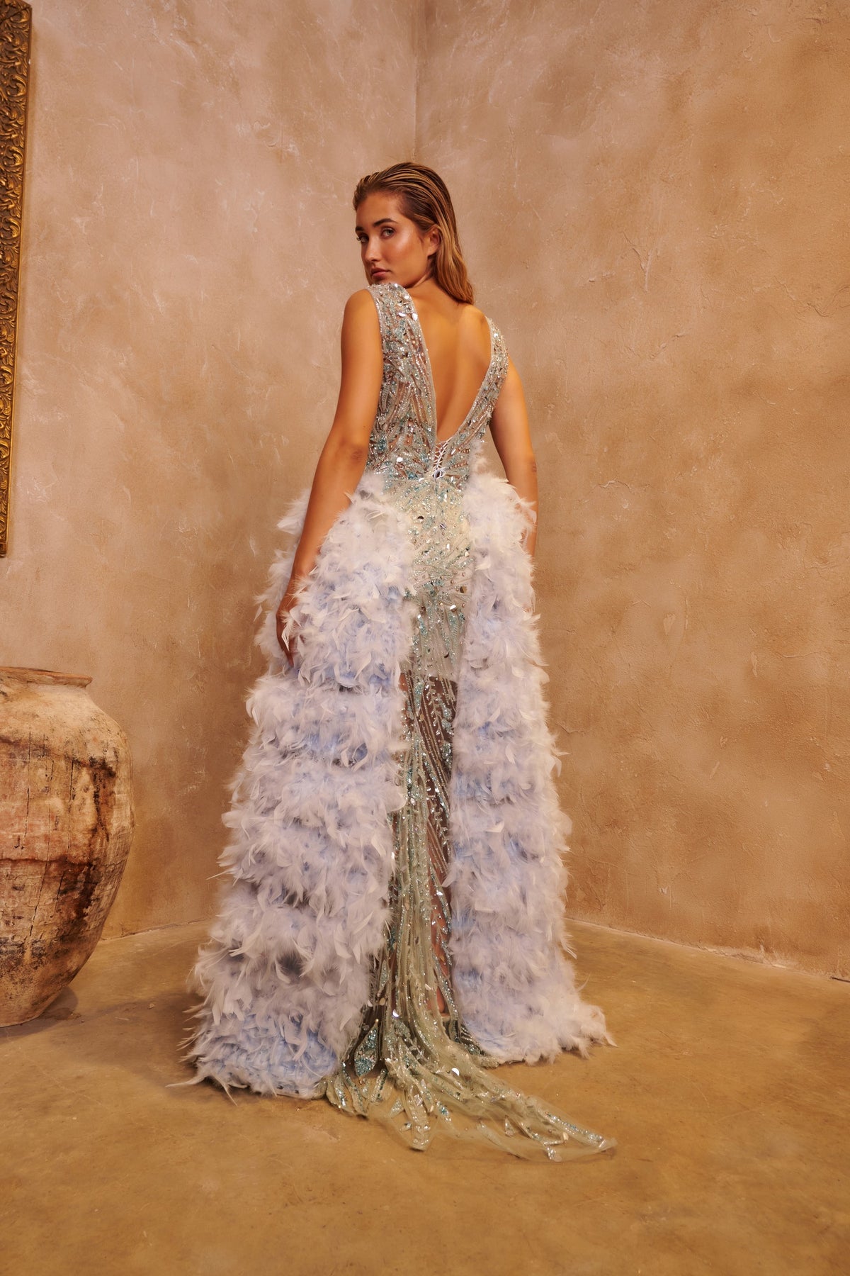 Celestial Plume embellished gown with a fitted silver bodice and dramatic lavender feather panels.