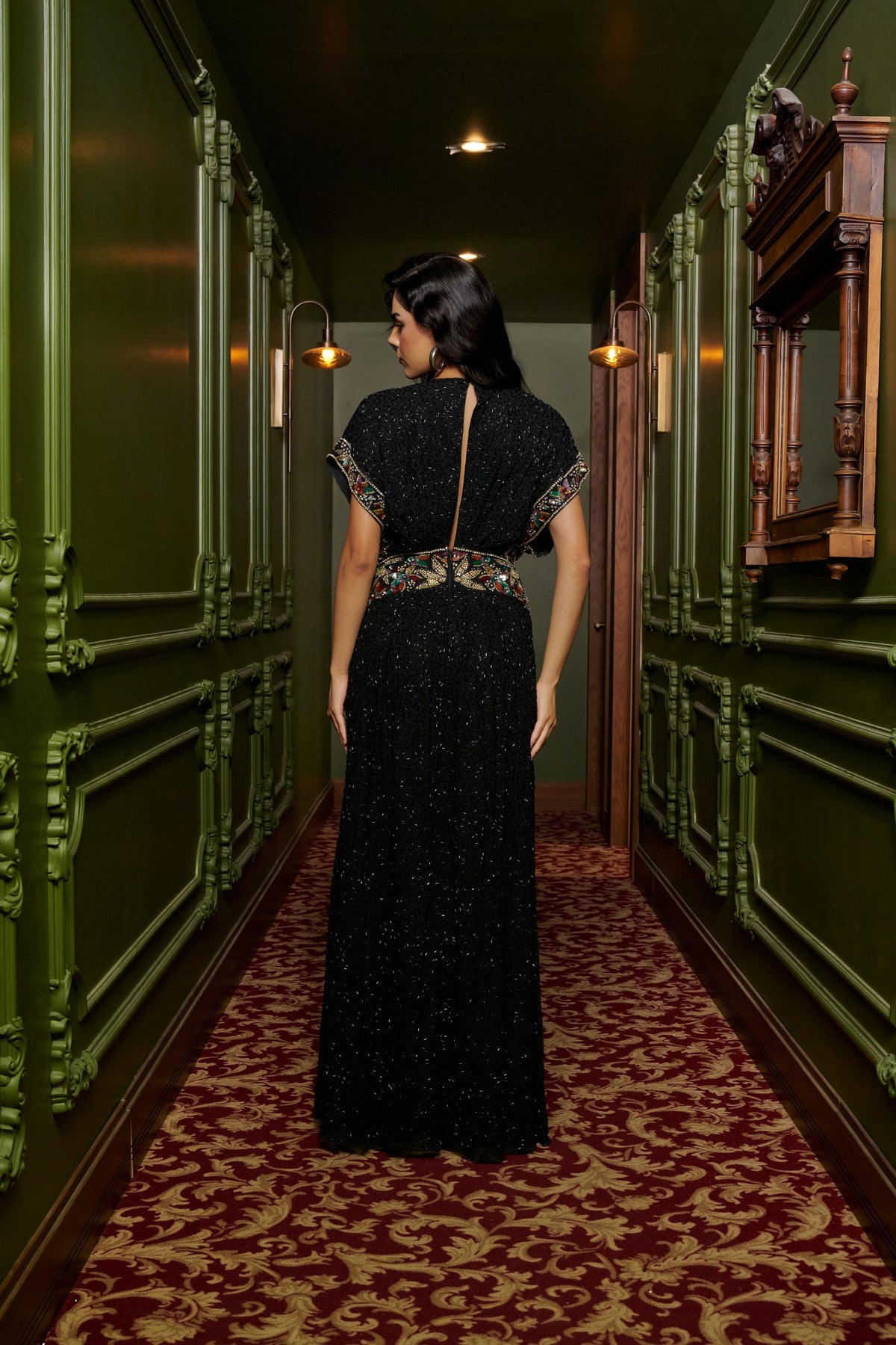 Black Jewel black tie dress with a deep V-neckline, multicolored embellishments, cap sleeves and a thigh-high slit.