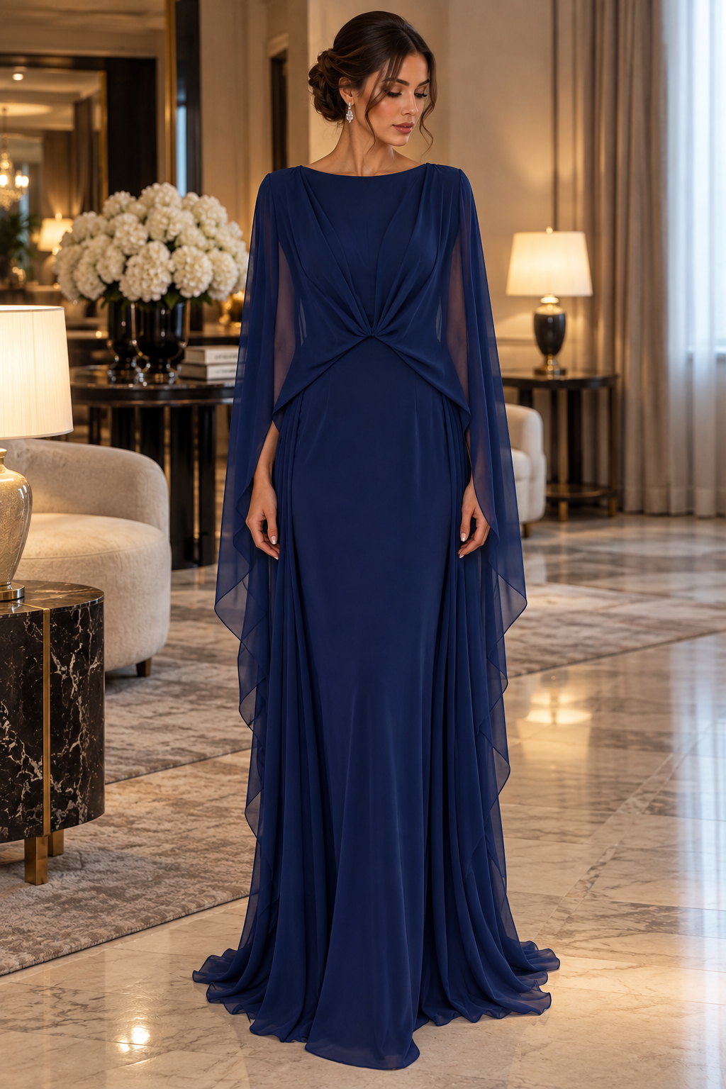 Éclat Gown in Navy Blue, a draped evening gown with sheer cape sleeves and a gathered waist.