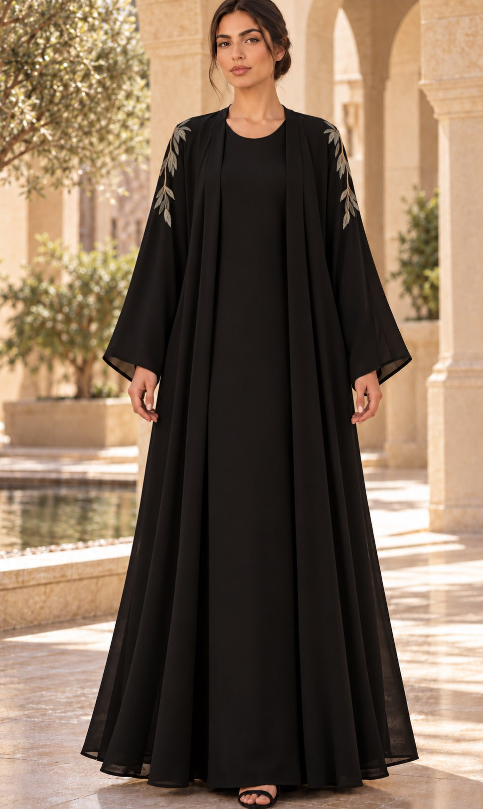 Willow black abaya with oversized botanical back detailing, champagne-toned accents and long, wide sleeves, front view