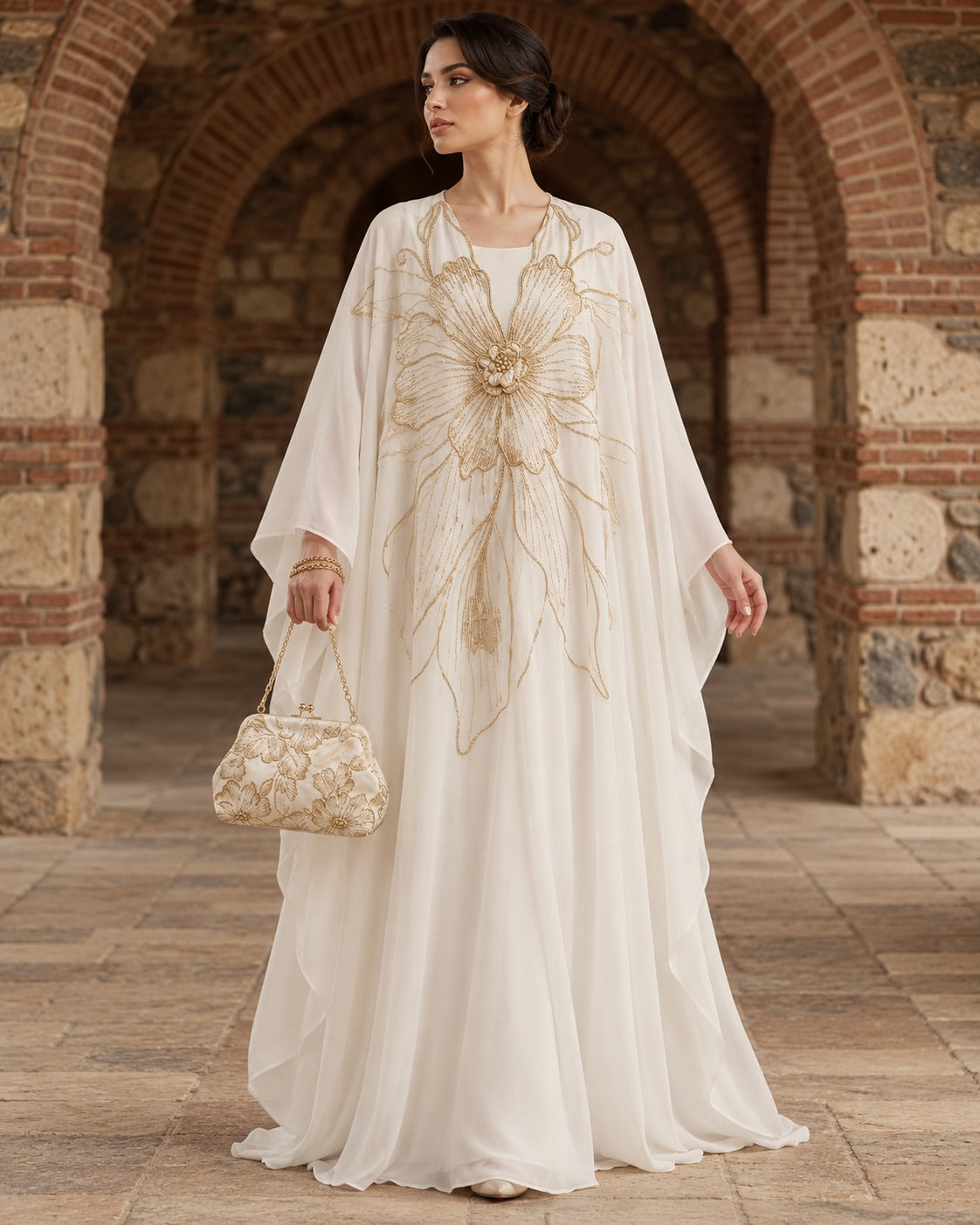 Zahra ivory kaftan abaya with an oversized gold floral motif, a rounded neckline and wide, draped sleeves, front view