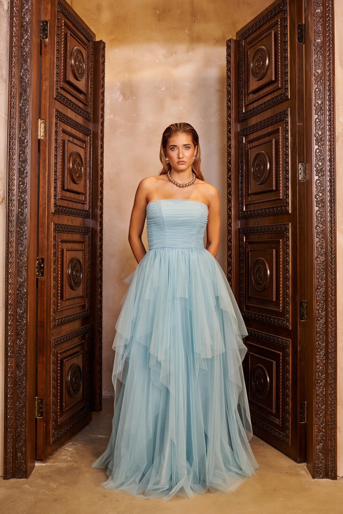 Blue Cloud powder blue ball gown with a strapless ruched bodice and a voluminous skirt with soft asymmetric layers.