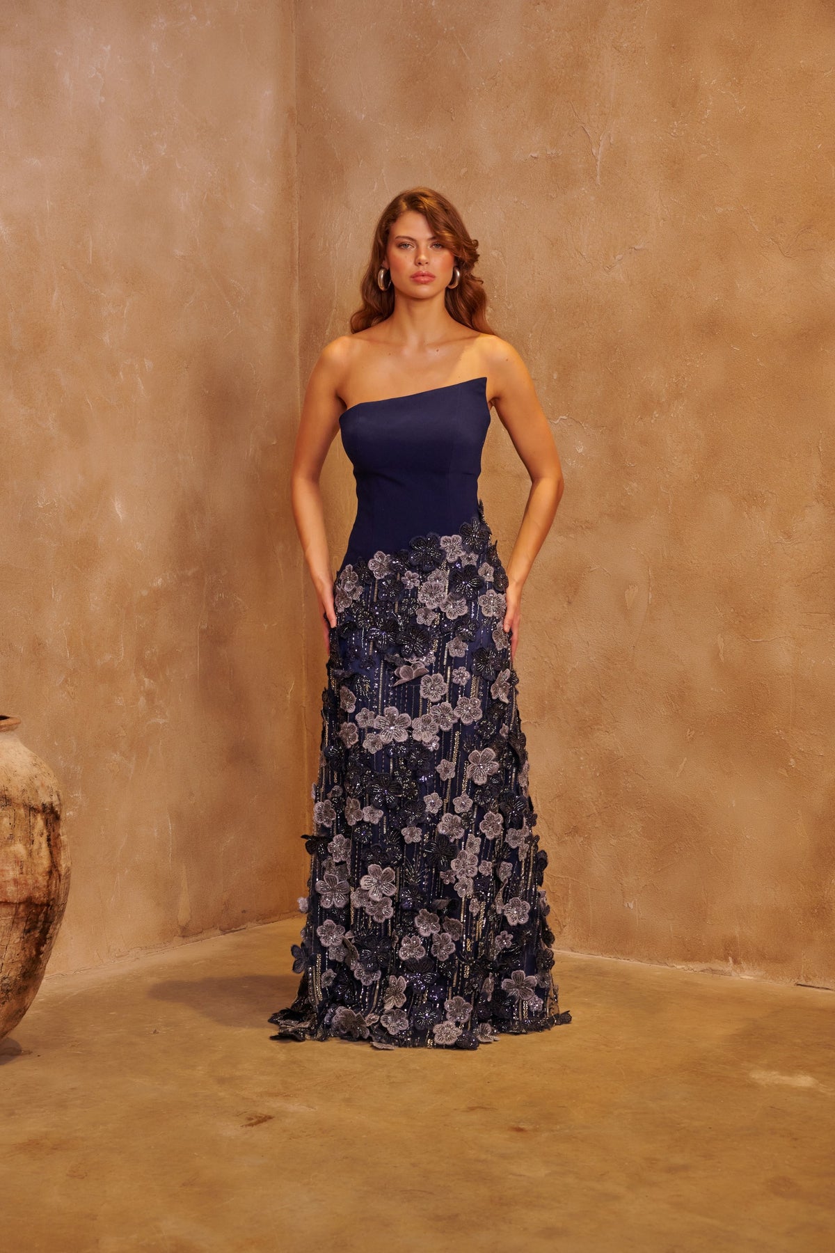 Moonlit Garden navy gown with an asymmetric bodice and a silver floral embellished floor-length skirt.