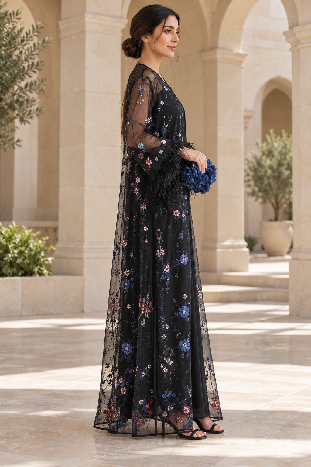 Layali black open-front abaya with sheer sleeves, multicolour floral detailing and statement feather-trim cuffs, side view