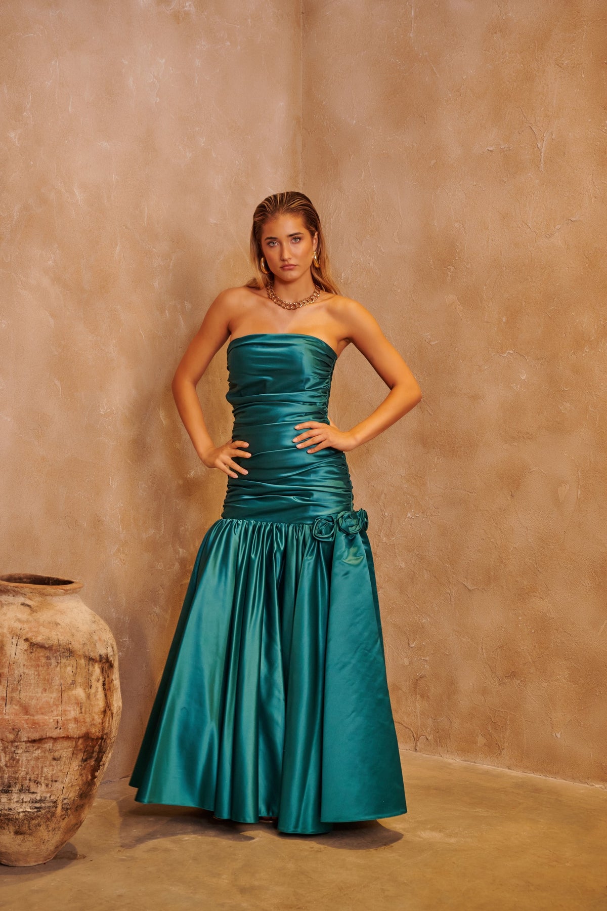 Emerald Rose green evening dress with floral-inspired embellishment and a sculpted fitted silhouette.