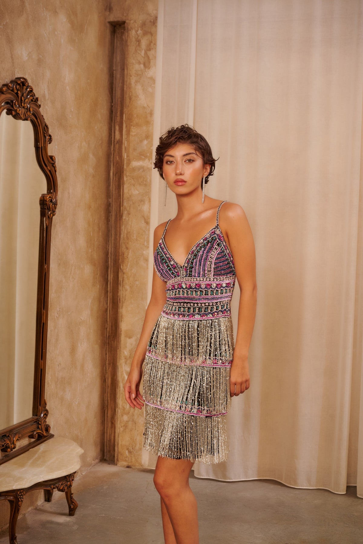 Rose Fringe embellished mini dress with multicolored beadwork, a deep V-neckline and layered blush fringe.