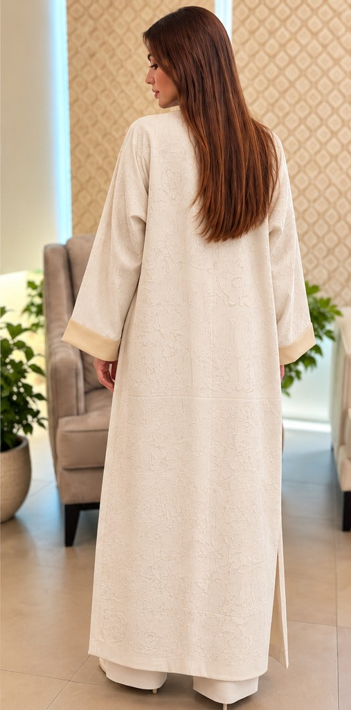 Qalam ivory open-front abaya with tonal Arabic calligraphy motifs, champagne gold edging and wide cuffs, back view