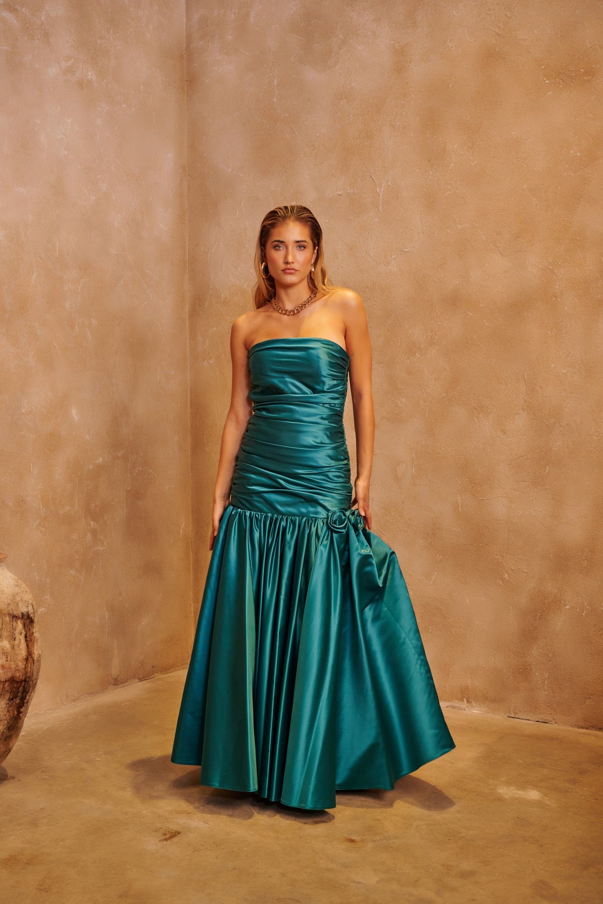 Emerald Rose green evening dress with floral-inspired embellishment and a sculpted fitted silhouette.