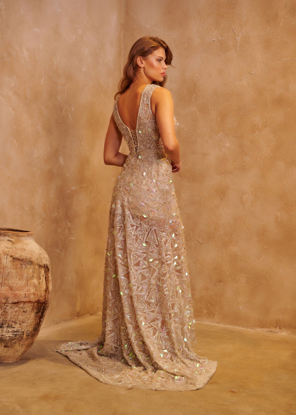 Champagne Prism floor-length gown with crystal embellishment, a sculpted neckline and a softly fitted silhouette.