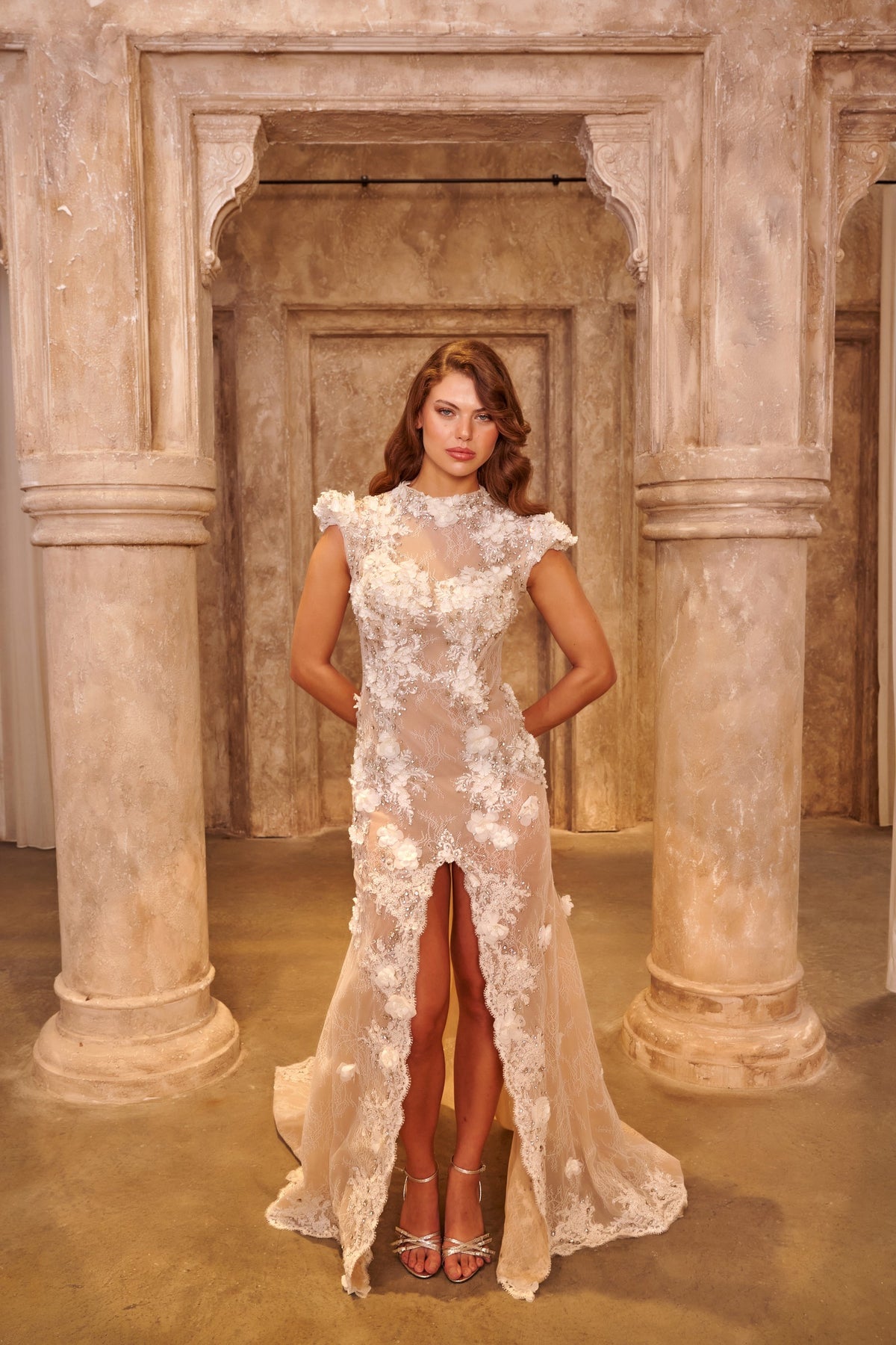 Ivory Lace white evening dress with a high neckline, sheer fitted bodice, floral appliqués and a front slit.
