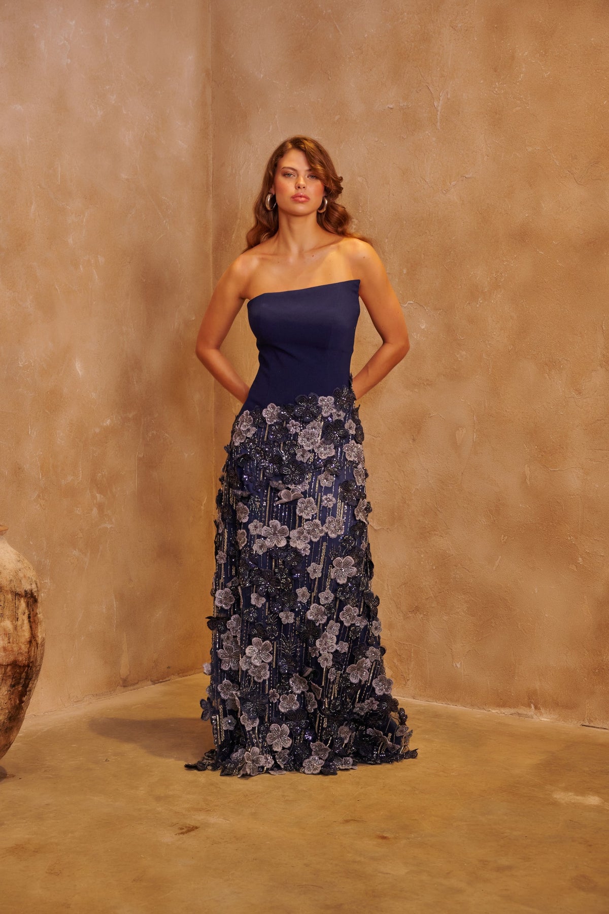 Moonlit Garden navy gown with an asymmetric bodice and a silver floral embellished floor-length skirt.