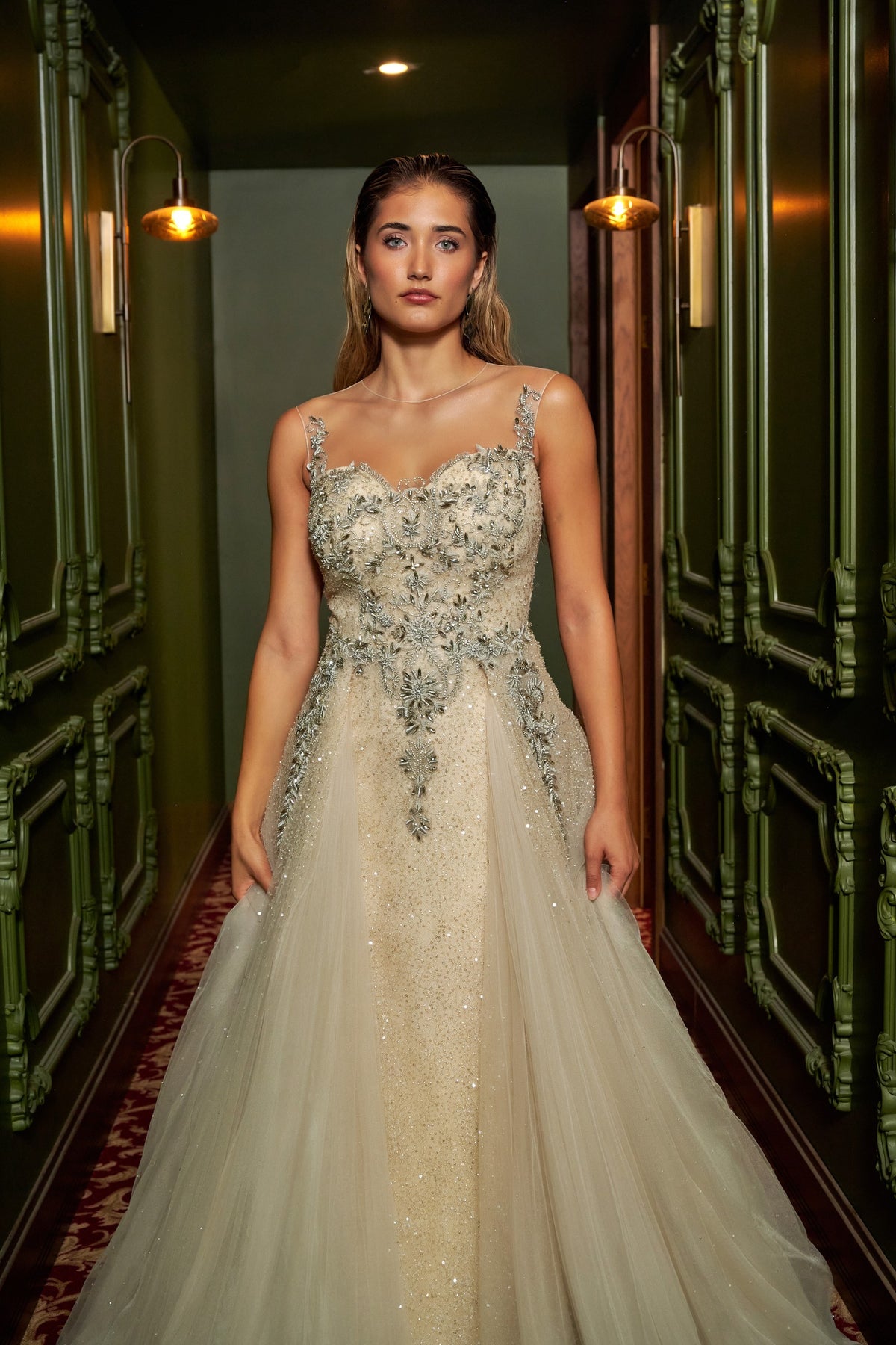 Ivory Dream floor-length evening gown with an embellished fitted bodice, delicate straps and a flowing overskirt.