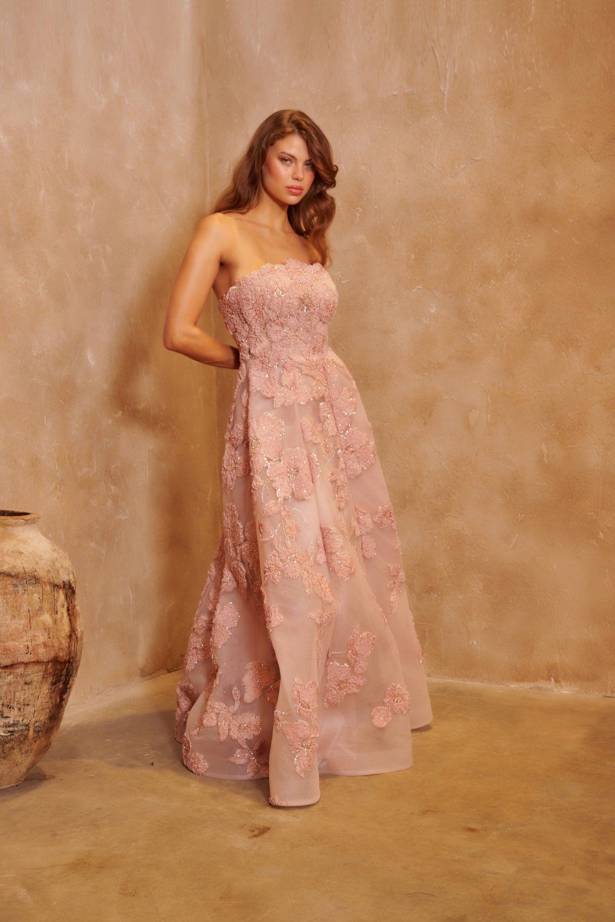 Petal Sonata blush gown with a strapless bodice, three-dimensional floral embellishment and a full skirt.