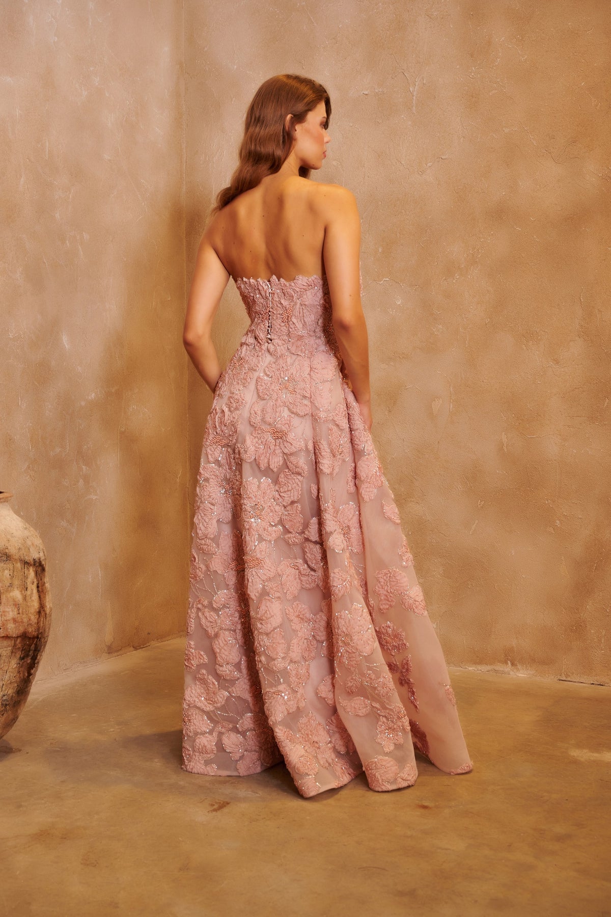 Petal Sonata blush gown with a strapless bodice, three-dimensional floral embellishment and a full skirt.