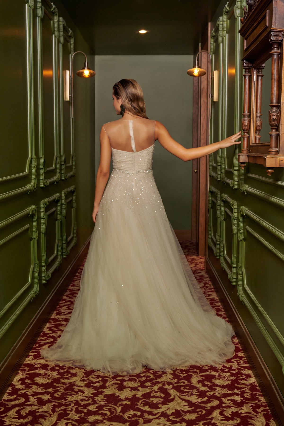 Ivory Dream floor-length evening gown with an embellished fitted bodice, delicate straps and a flowing overskirt.