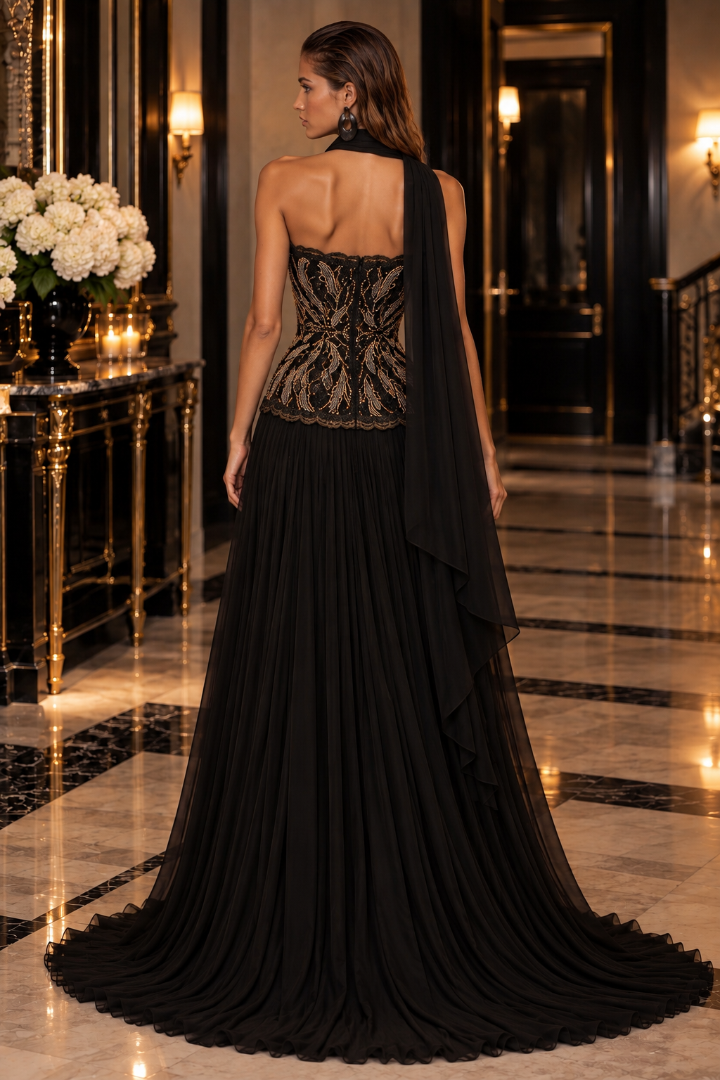 Floral Cascade evening gown in Black and Gold with a strapless gold beaded vine-embroidered bodice, flowing pleated skirt with train and draped scarf.